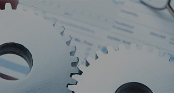 toothed gears placed on a notebook